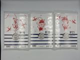 three silver coins in plastic bags on a white surface
