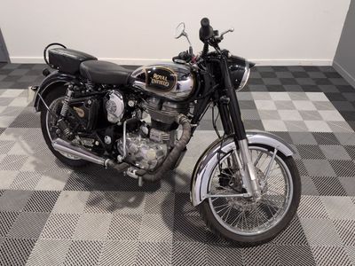 a motorcycle that is parked on a checkered floor