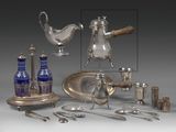 a silver plate and silverware on display on a table