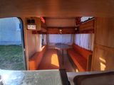 a view of the inside of a camper with a couch and a sink