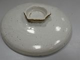 a white plate with a crack in it on a table