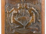 an antique bronze plaque depicting three nudes in a garden