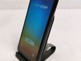 a phone that is sitting on a stand on a table