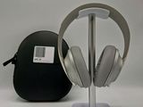 a pair of headphones sitting on a stand next to a bag
