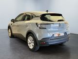 the rear of a silver car parked in a showroom