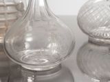 three glass vases sitting on a table next to each other