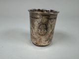 a silver cup that is sitting on a table