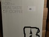 a cardboard box that has a picture of a coffee maker on it