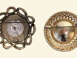 two brooches that are sitting on a table