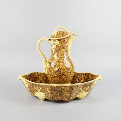 an image of a gold colored pitcher and a bowl on a table