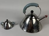 two tea kettles sitting next to each other on a table