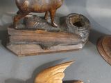 a small statue of a deer and a bird on a table