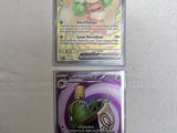 two pokemon cards sitting on top of each other on a table