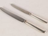 two knives that are sitting next to each other on a table