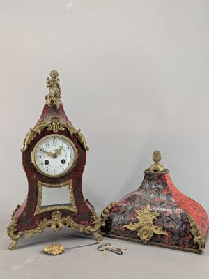 two clocks sitting next to each other on a table