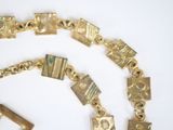 a gold chain that has a bunch of gold charms on it