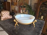a white bowl sitting on top of a wooden table