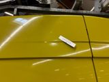 a yellow surfboard sitting on top of a table