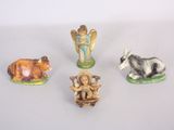 four figurines of animals on a white surface