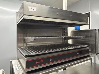 stainless steel counter top grill with open door in commercial kitchen