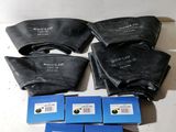 four bags of blue and black ink sitting on top of a white table