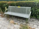 a bench that is sitting on the side of the road