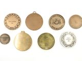 several different types of medals are shown on a white surface