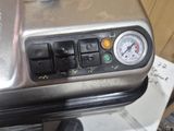 a silver and black air fryer sitting on a counter