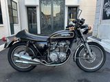 a black motorcycle parked in front of a building