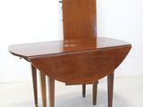 a small wooden table with a mirror on top of it