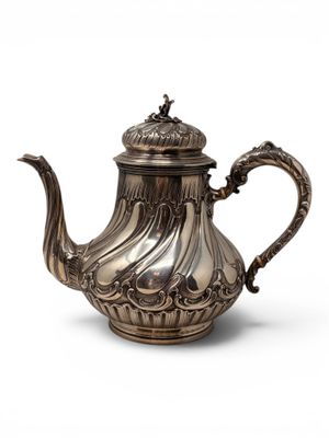 a silver tea pot with a handle on a white background