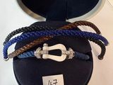 three bracelets that are sitting on a black case