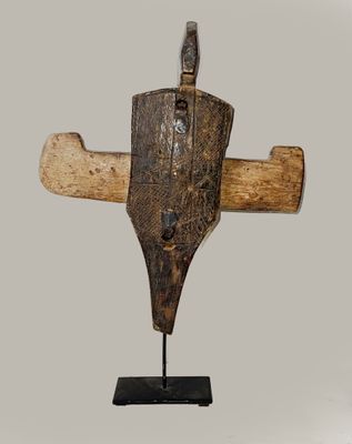 an image of a wooden sculpture of a cross on a stand