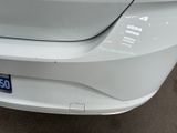 a close up of a white car with a number plate on it