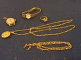 several pieces of jewelry are laying out on a blue surface