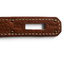 a close up of a brown leather strap on a white background