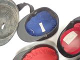 five hats that are lined up on a white surface