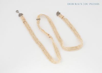 two pearl necklaces and a pair of earrings on a white surface