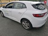 a white car that is parked on the side of the road