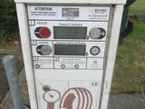 a parking meter on the sidewalk in front of a house