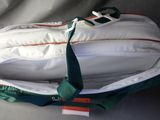 a white backpack with a green tie on it