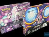 two boxes of pokemon trading cards with a unicorn on top of them