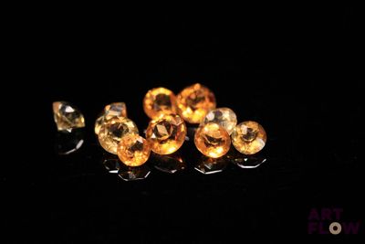 some yellow diamonds are laying on a black surface