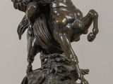 statue of a man riding a horse on a rock on a table