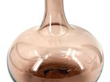 a glass vase that is sitting on a white surface