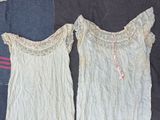 pair of women ' s nightgowns on a bed next to a pillow