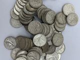 a pile of silver coins sitting on a white surface