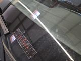 a sticker on the windshield of a car with a sticker on it