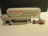 a toy truck and a toy truck with a box in the background