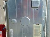 a metal door that is open on the side of a refrigerator